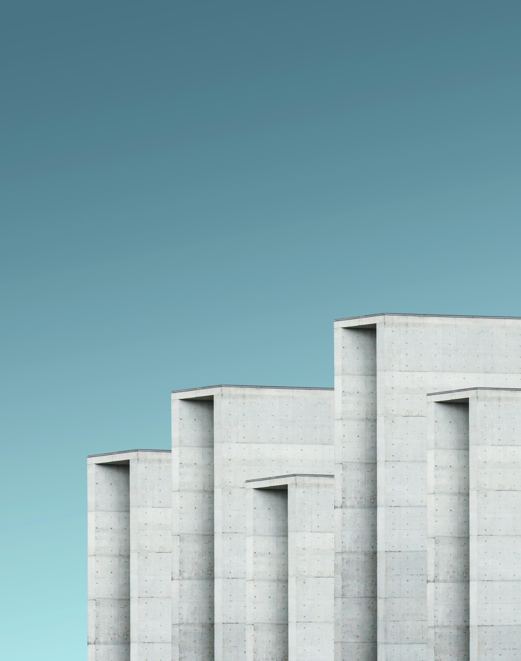 Concrete architectural volumes against an open blue sky